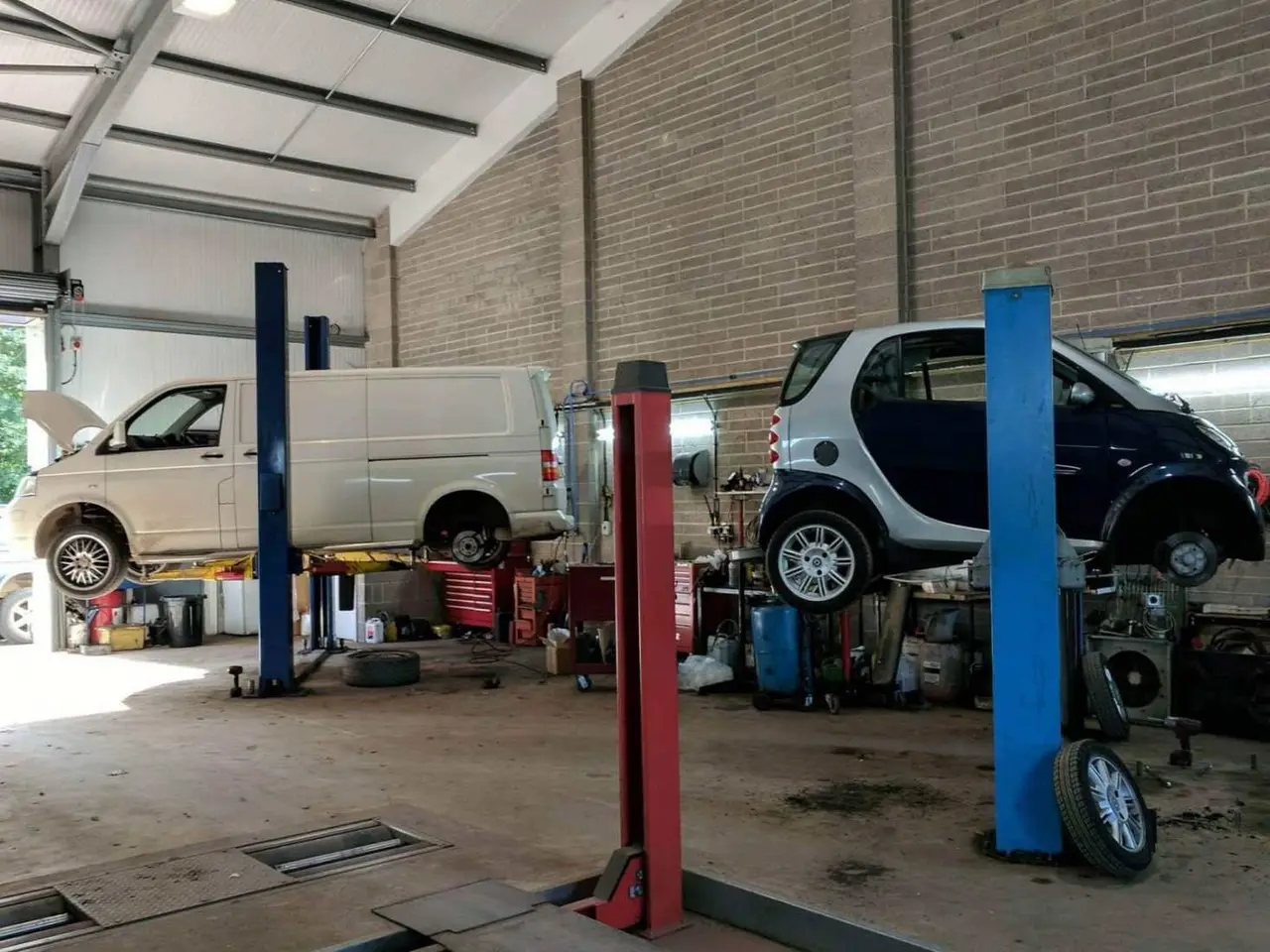 Workshop vehicle lifts with a small car and a van RPM Motor Services Seaton