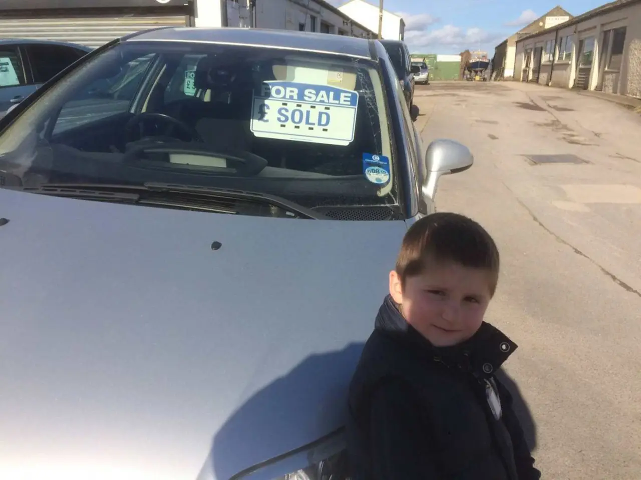 Young customer with a newly sold car at RPM Motor Services Seaton