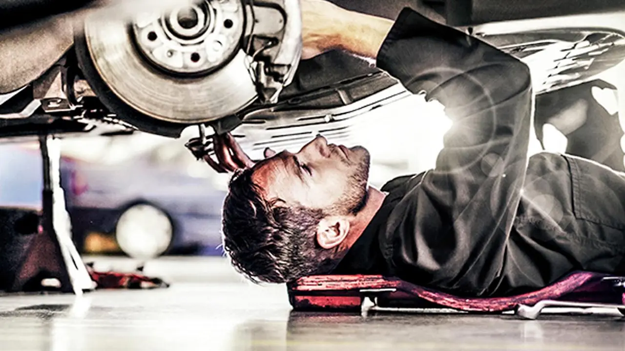 Technician repairing a car brake assembly RPM Motor Services Seaton
